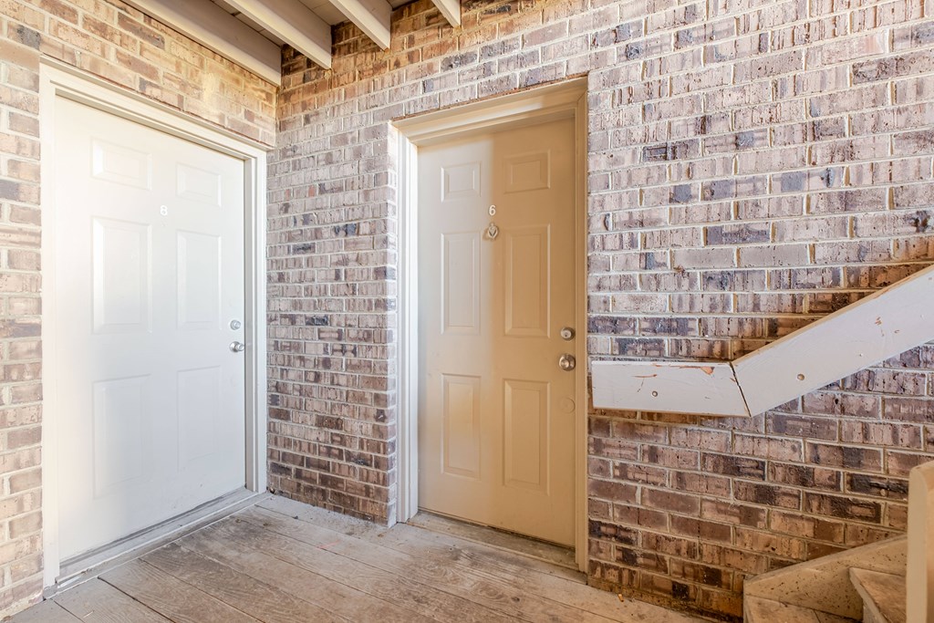 A white door is on the left and a beige door is on the right.