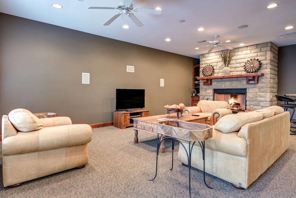 a living room with couches and a fireplace and a table