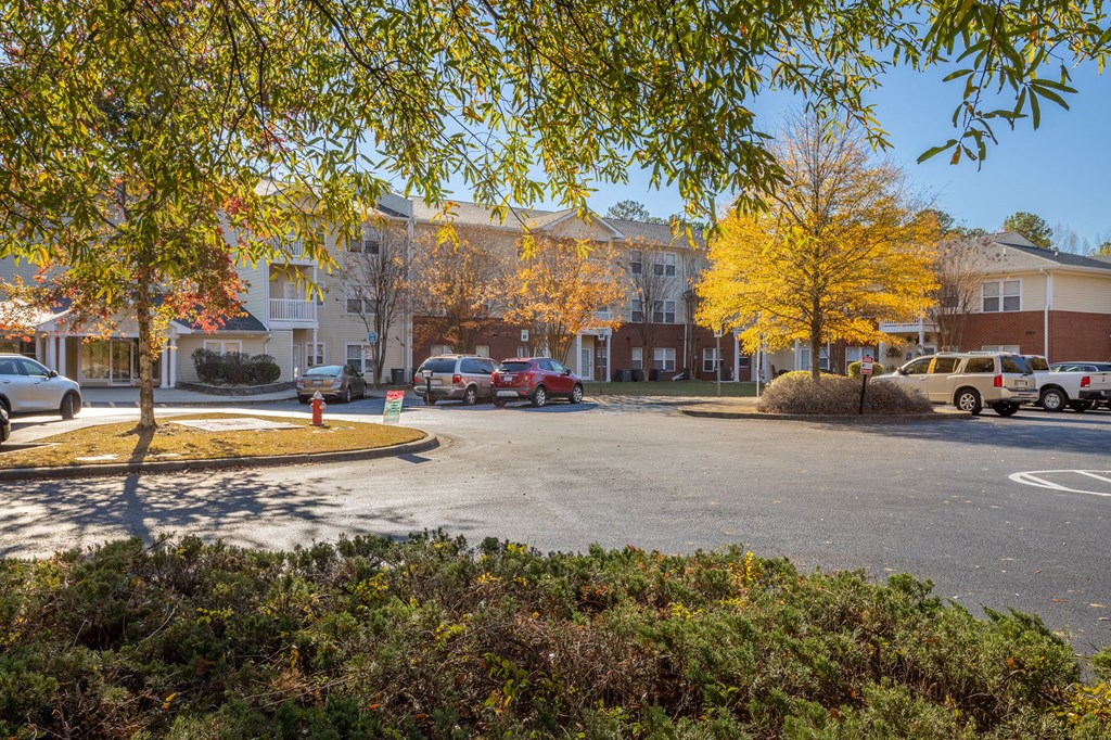 a parking lot at the whispering winds apartments in pearland, tx