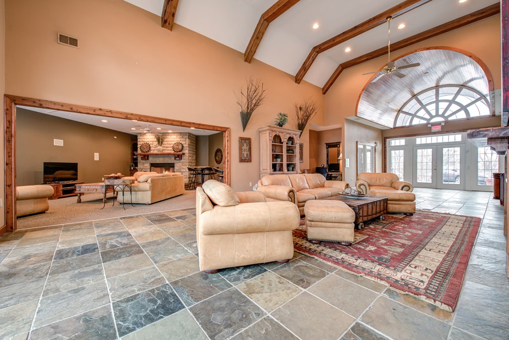 a large living room with couches and a fireplace