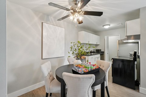 A dining room with a table set for a meal.