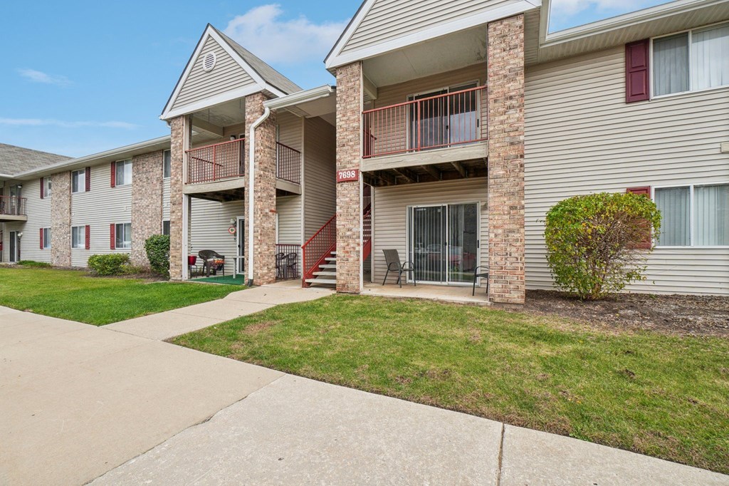 Apartment building with a red sign on the pillar.