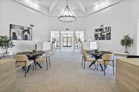 A modern dining room with a large table and chairs.