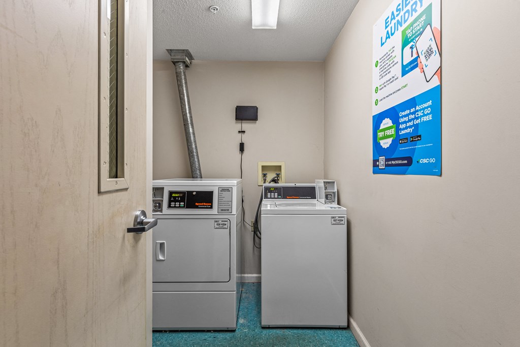 a laundry room with two washers and two washing machines