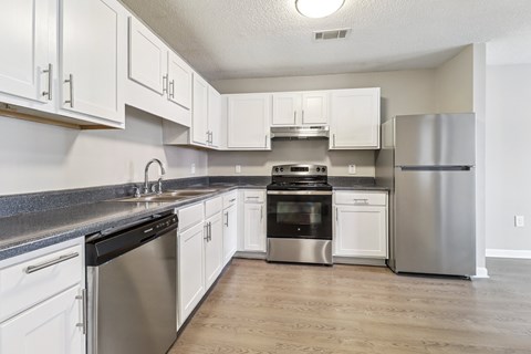 A kitchen with white cabinets and stainless steel appliances.