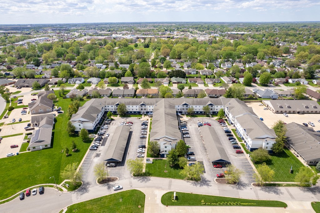 an aerial view of a parking lot of houses in a neighborhood