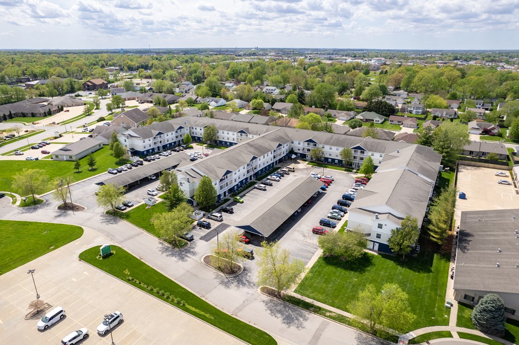 an aerial view of a parking lot and buildings in a city