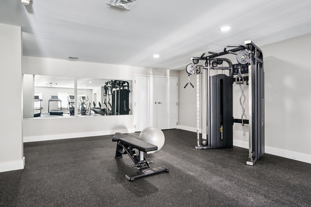A gym with a variety of equipment including a leg press machine.