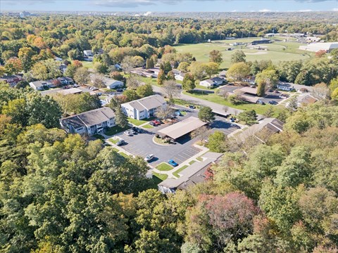 An aerial view of a residential area with houses and trees.