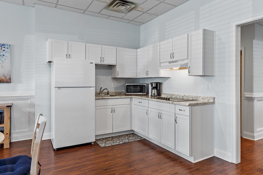 a kitchen with white cabinets and a counter top