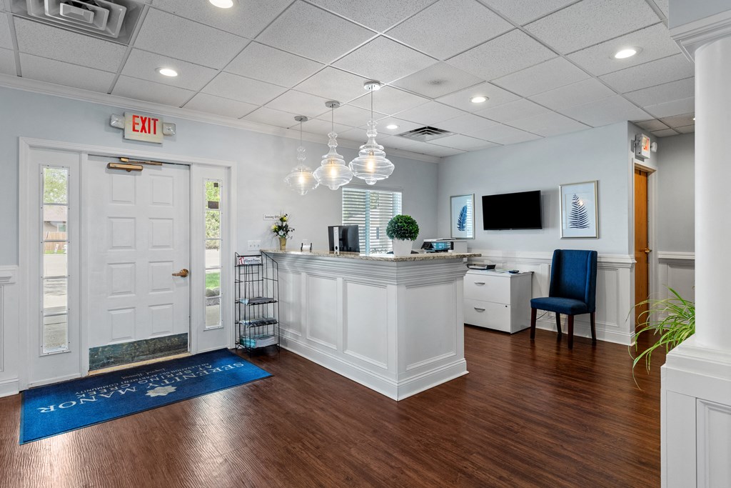 a lobby with a reception desk and an exit sign