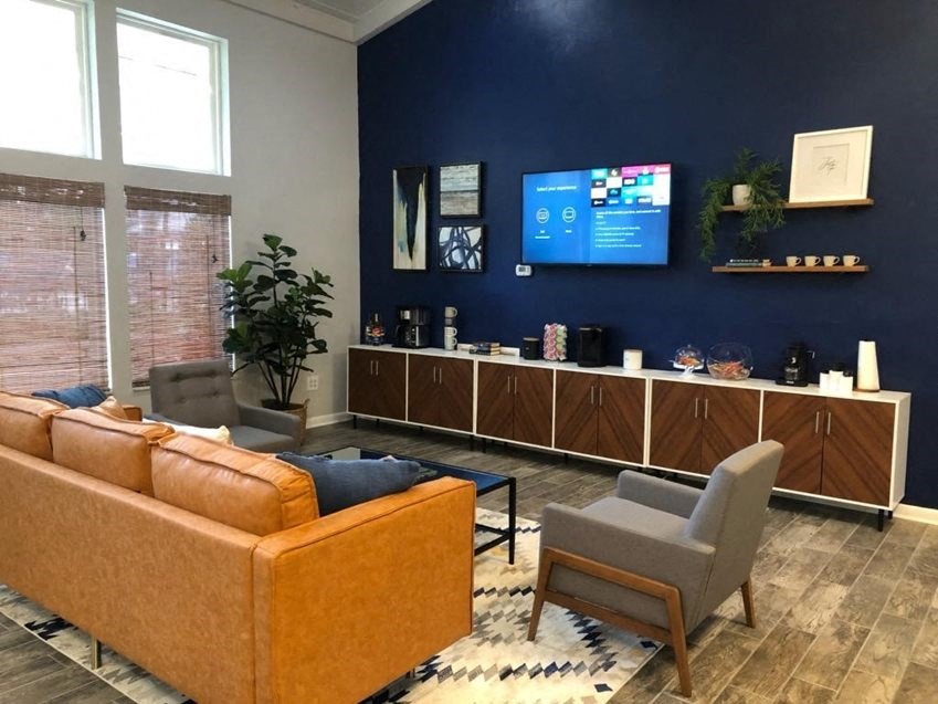 a living room with a couch chairs and a tv