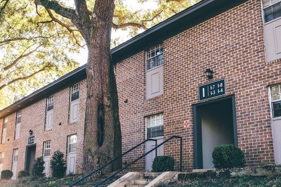 a brick building with a tree in front of it