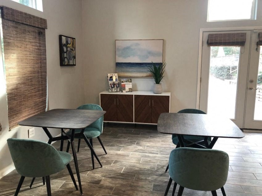 a room with a table and chairs and a door