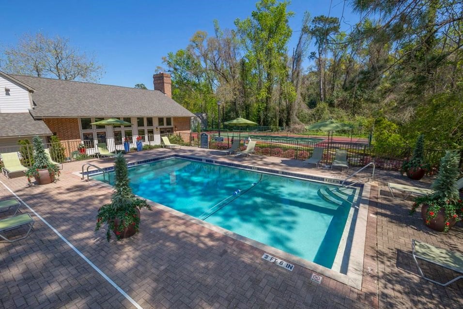 a swimming pool with a house in the background