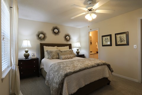 a bedroom with a large bed and a ceiling fan