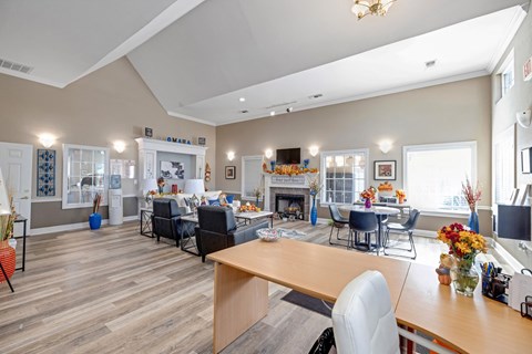 Well-lit clubhouse room with fireplace and dining area at Cambury Hills Apartments in Omaha, Nebraska