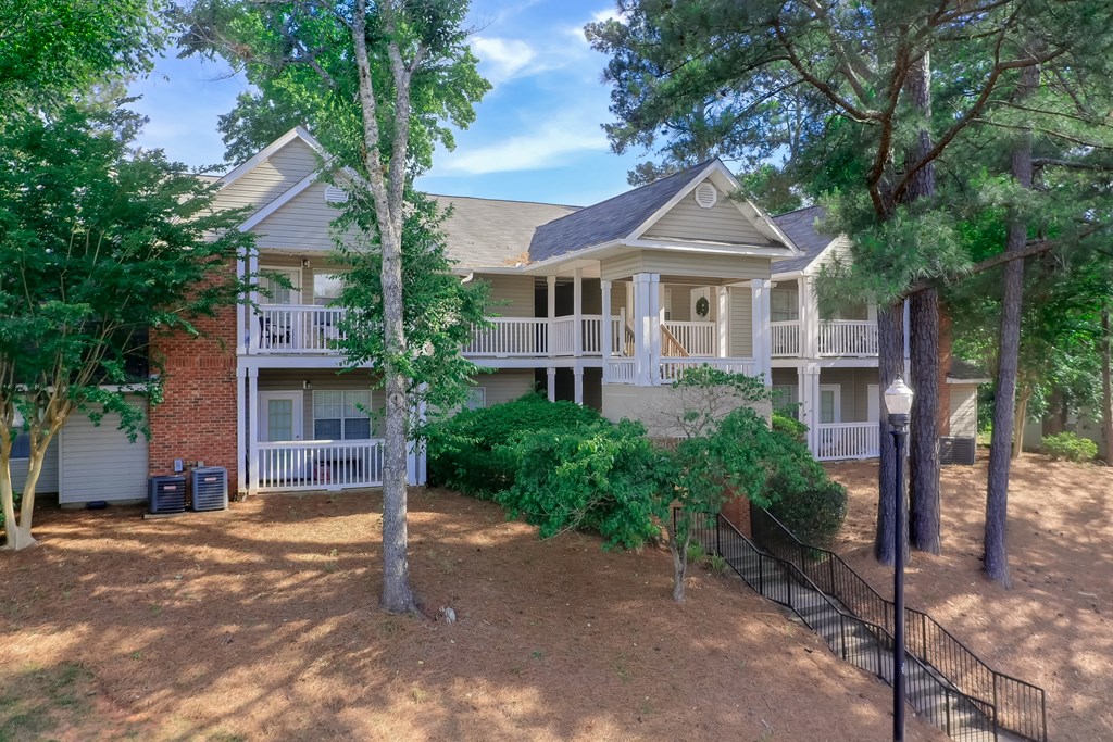 the exterior of a house with trees in front of it
