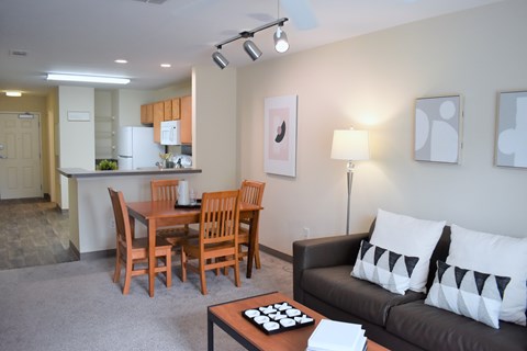 A living room with a dining table and chairs.