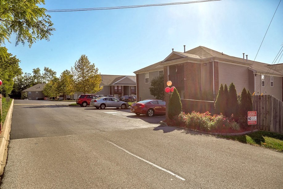 a street with cars parked in front of houses