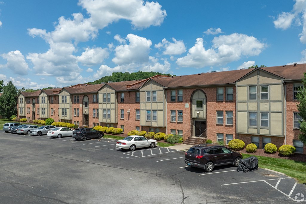 an apartment building with cars parked in front of it