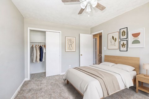 A bedroom with a large bed and a wardrobe.