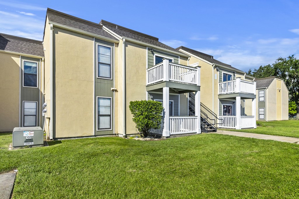 a row of apartments with balconies and grass