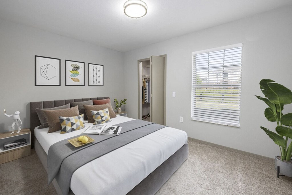 a bedroom with a large bed and a large window