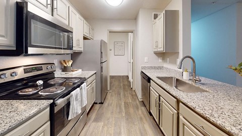 a kitchen with stainless steel appliances and granite counter tops