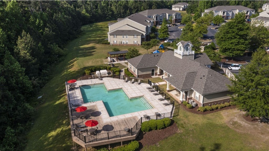 an aerial view of a large house with a large pool in the backyard