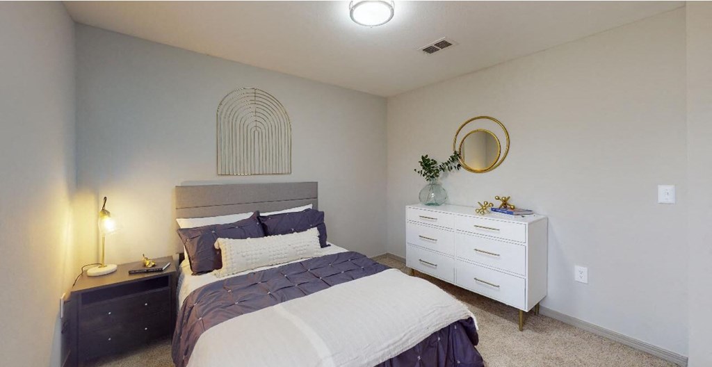 a bedroom with a bed and a dresser