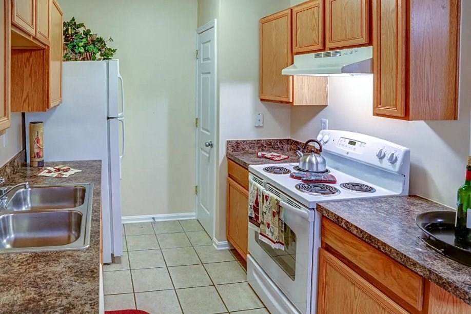 a kitchen with a stove refrigerator and a sink