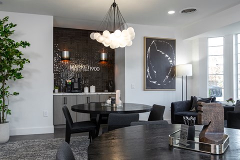 A black and white dining room with a round table and chairs.