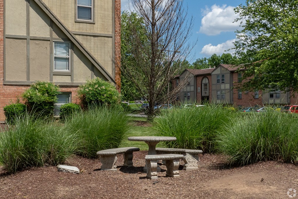 a group of stone benches in front of a building