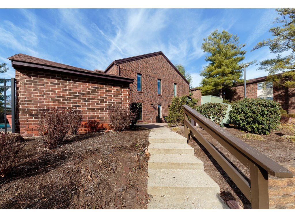 a brick building with a wooden fence in front of it