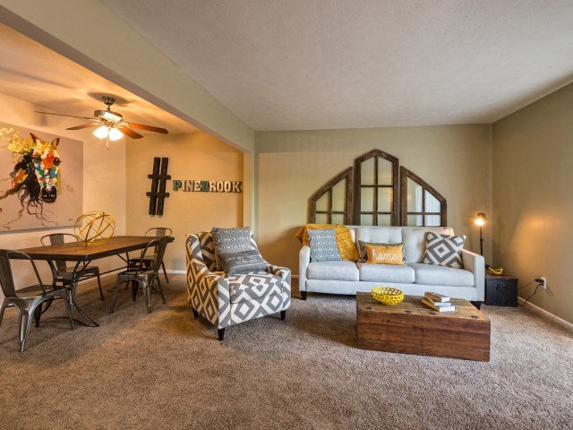 a living room with a couch chair and table