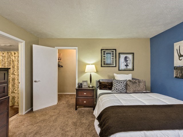 a bedroom with a bed and a nightstand