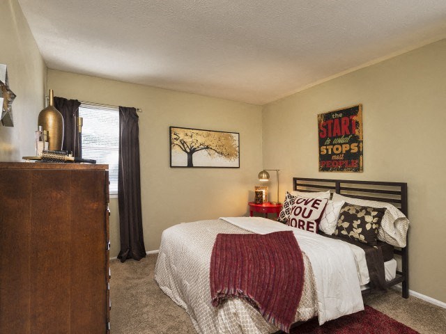 a bedroom with a bed and a dresser