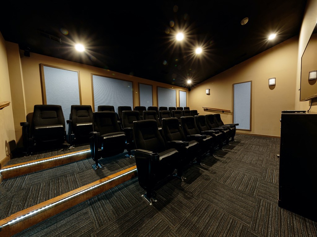 an empty auditorium with chairs and a podium