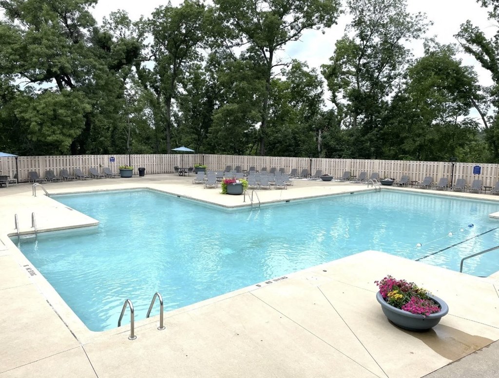a swimming pool with chairs around it