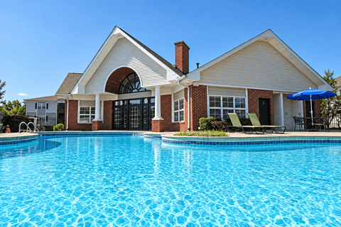 A house with a pool in front.