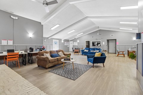 A spacious office with a variety of seating options and a modern design.