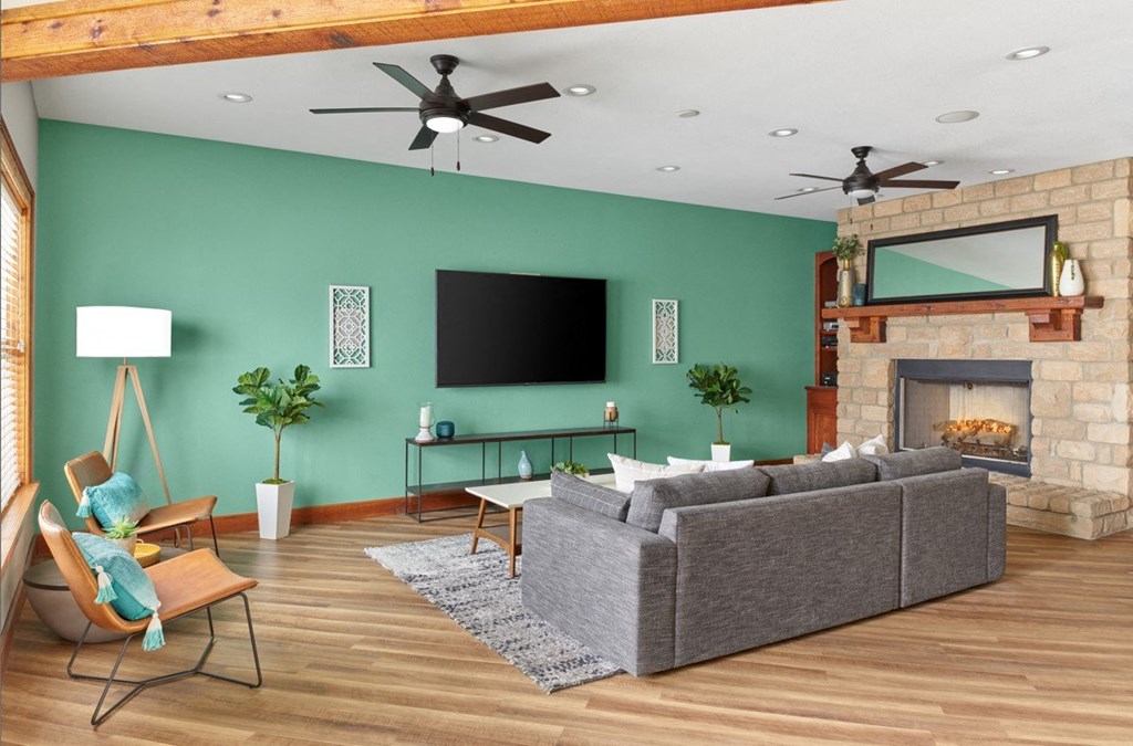 a living room with a couch and a fireplace and a tv