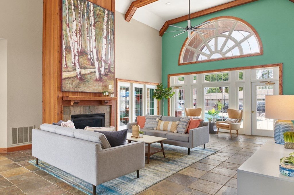 a living room with couches and chairs and a fireplace