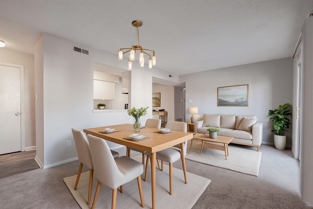 A dining room with a wooden table and chairs.