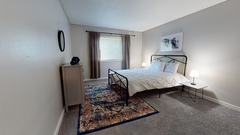 a bedroom with a bed in a room