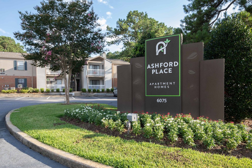 a sign at the entrance of ashwood place apartments