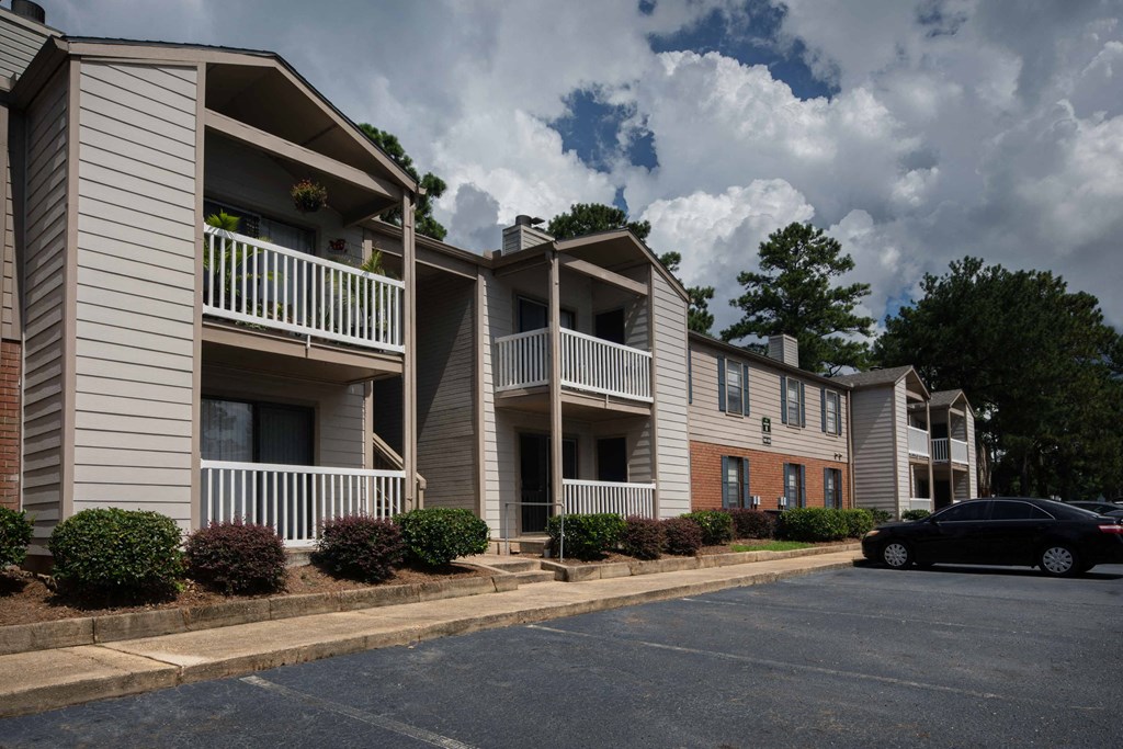 an empty parking lot in front of an apartment complex