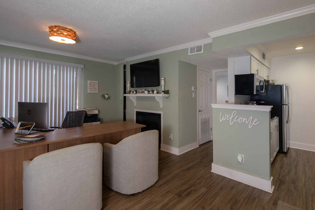 a room with a fireplace and a desk with a computer