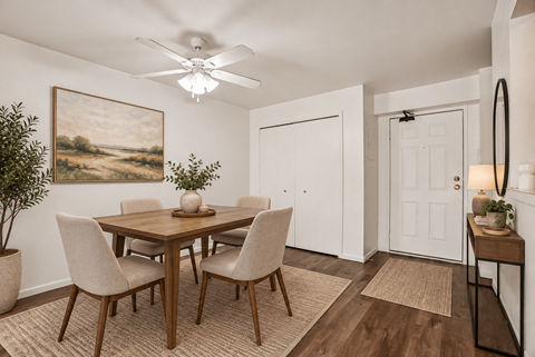 A dining room with a wooden table and chairs.
